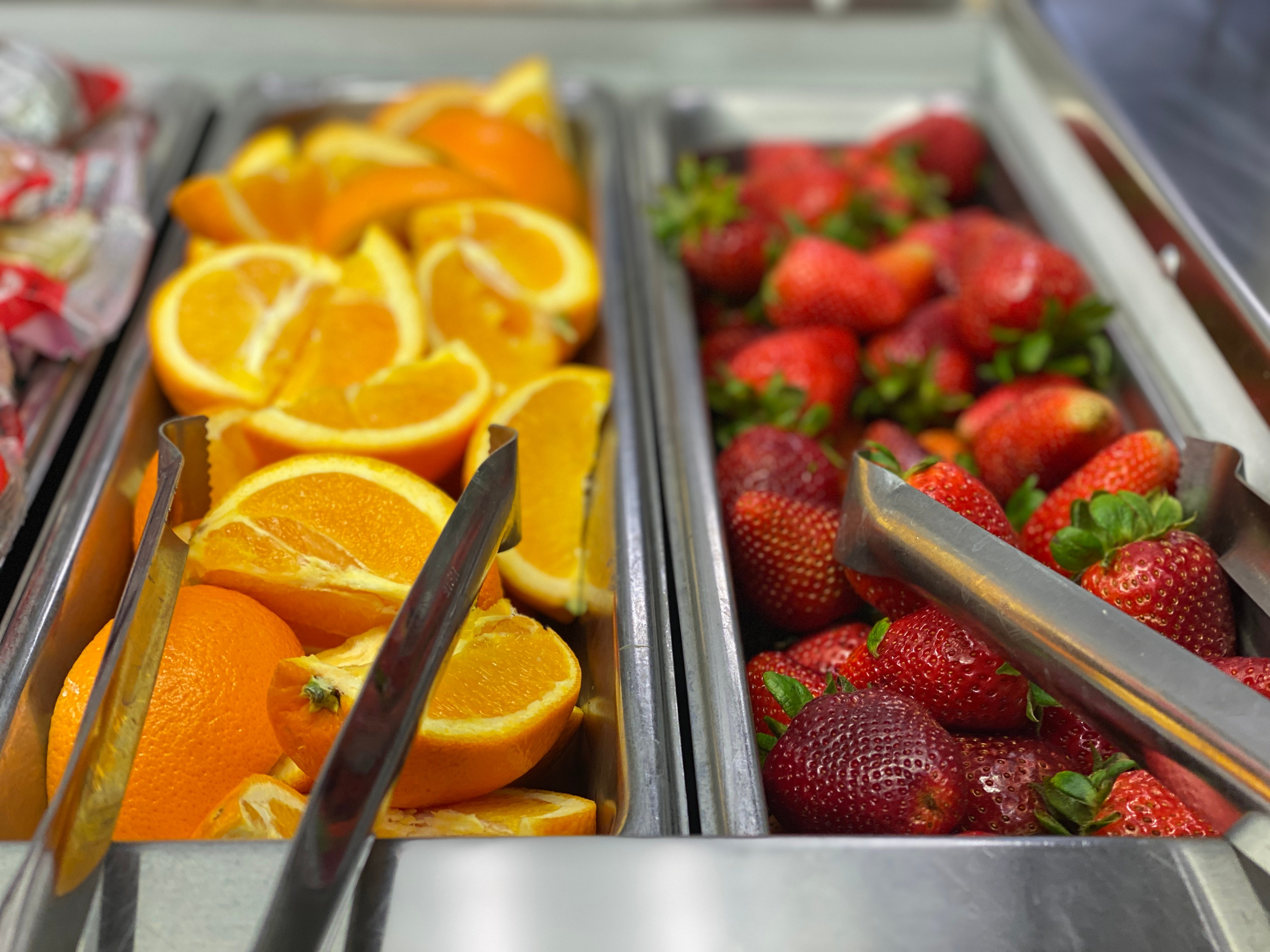 Orange wedges and strawberries on the garden bar.