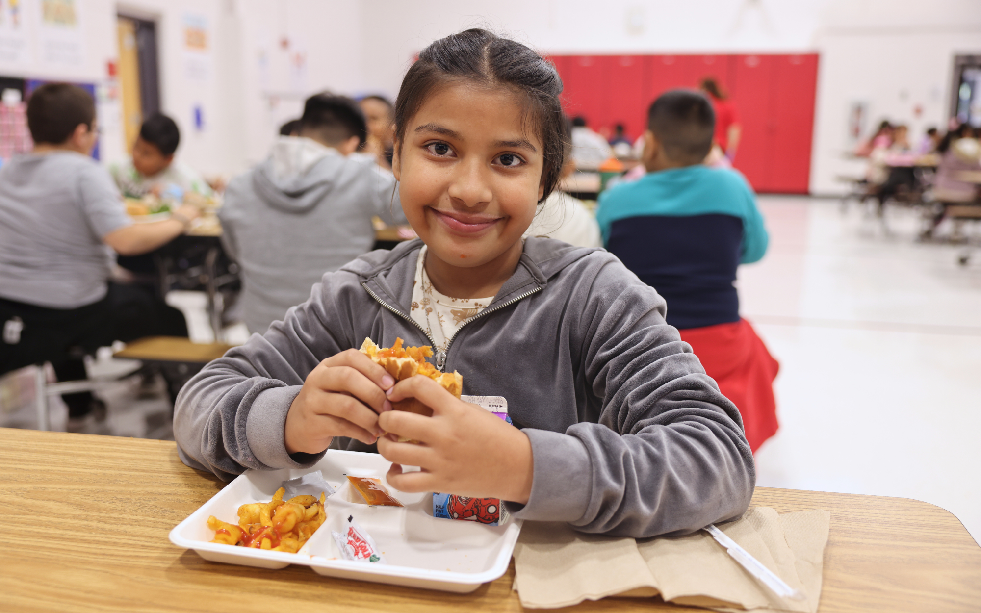 Student eating a chicken sandwich