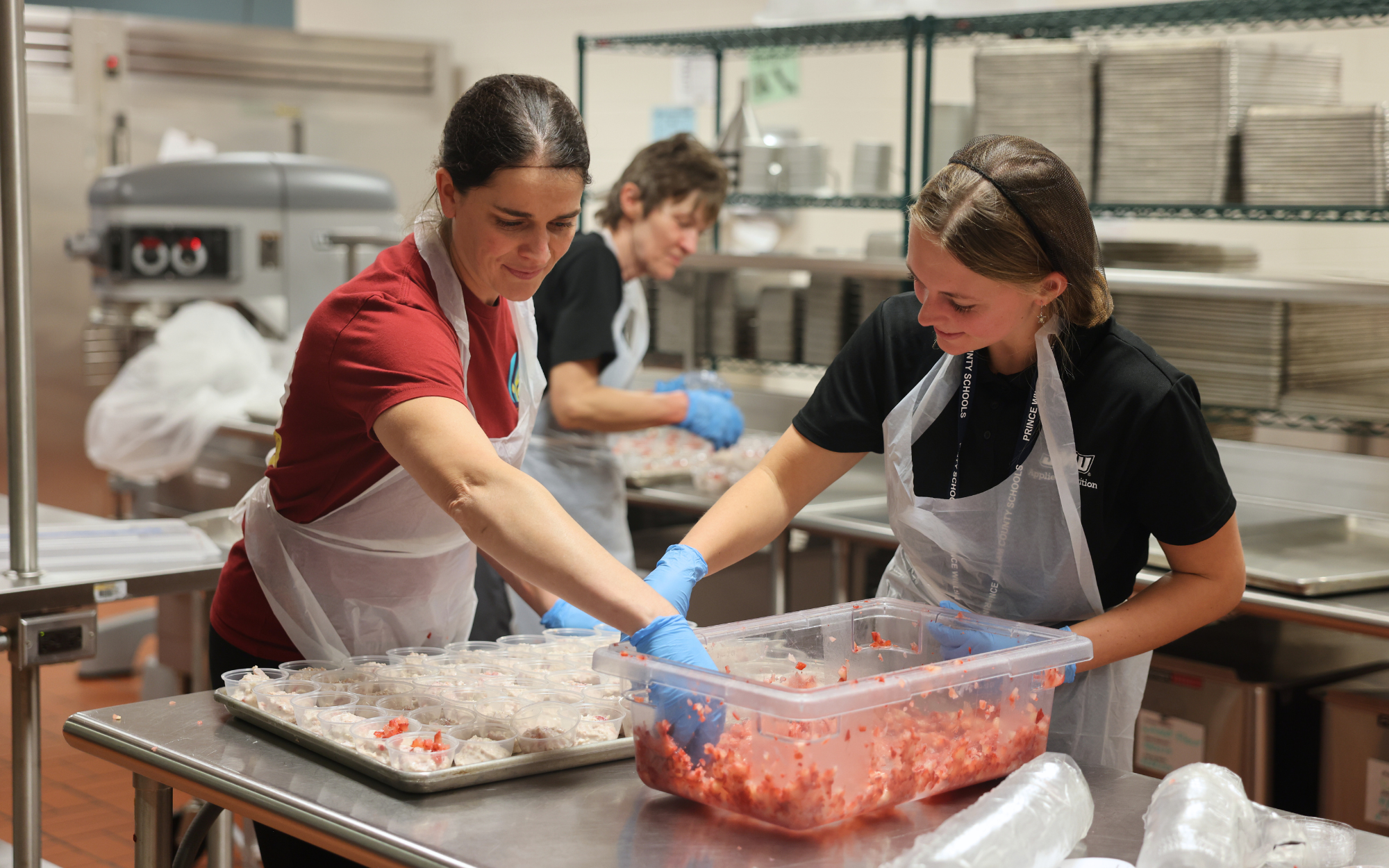 Team members making strawberry parfaits