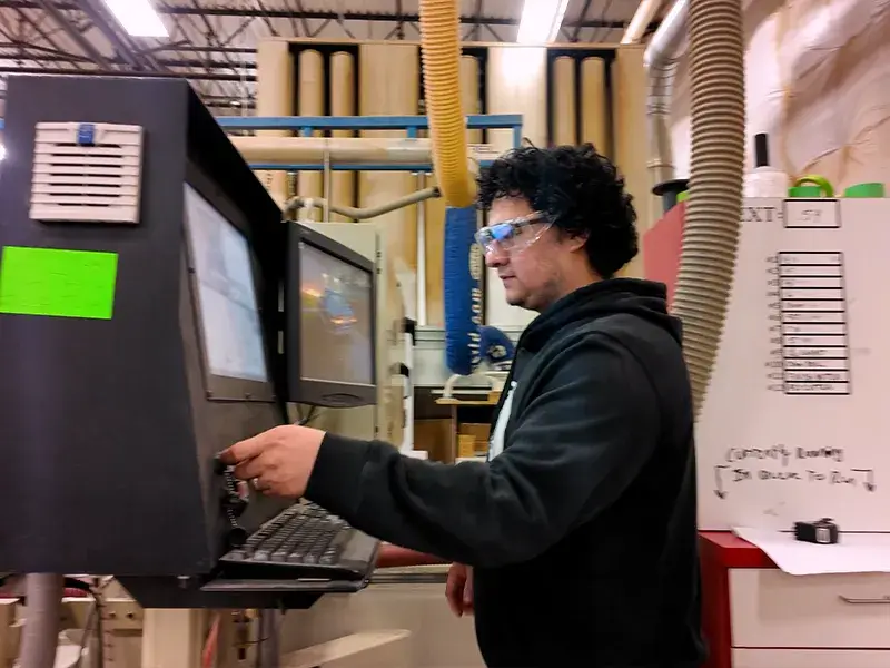 Student participating in a work-based learning program operating a millwright machine