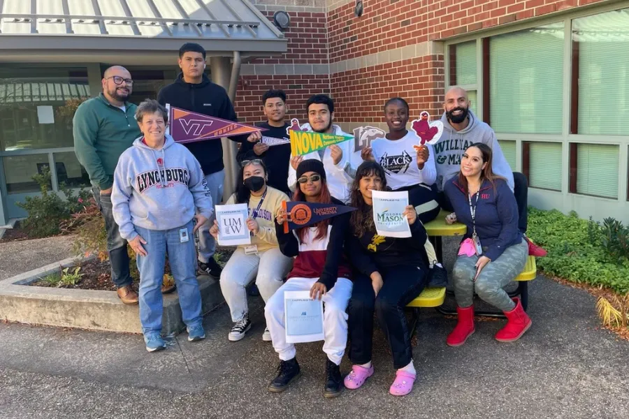 Freedom High Schools students and staff holding signs and wearing sweatshirts of colleges