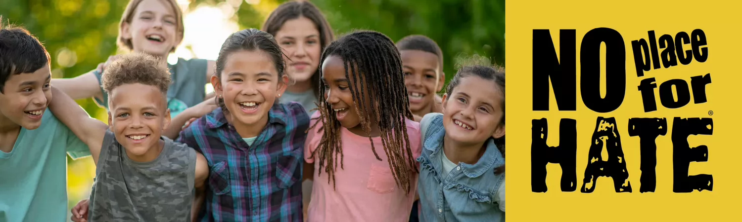 group of children smiling with No Place for Hate logo