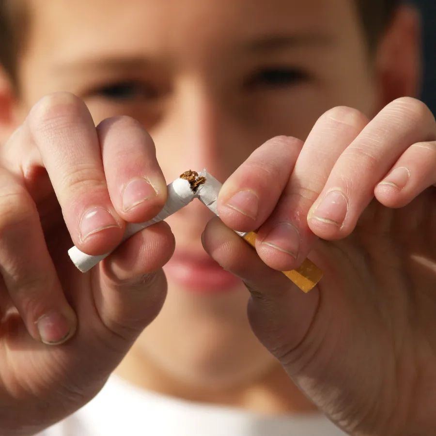 Boy breaking a cigarette