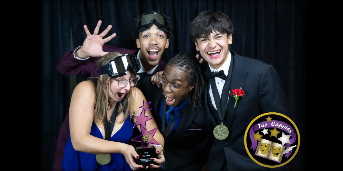 Four students posing with awards