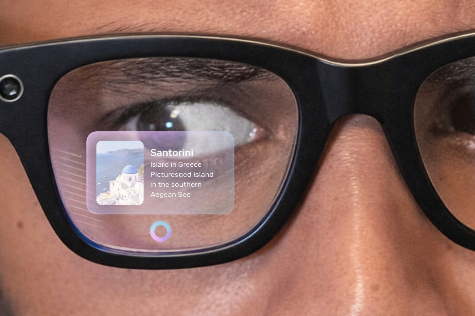 Close-up of a person wearing smart glasses with an augmented reality info card about Santorini displayed on the lens.