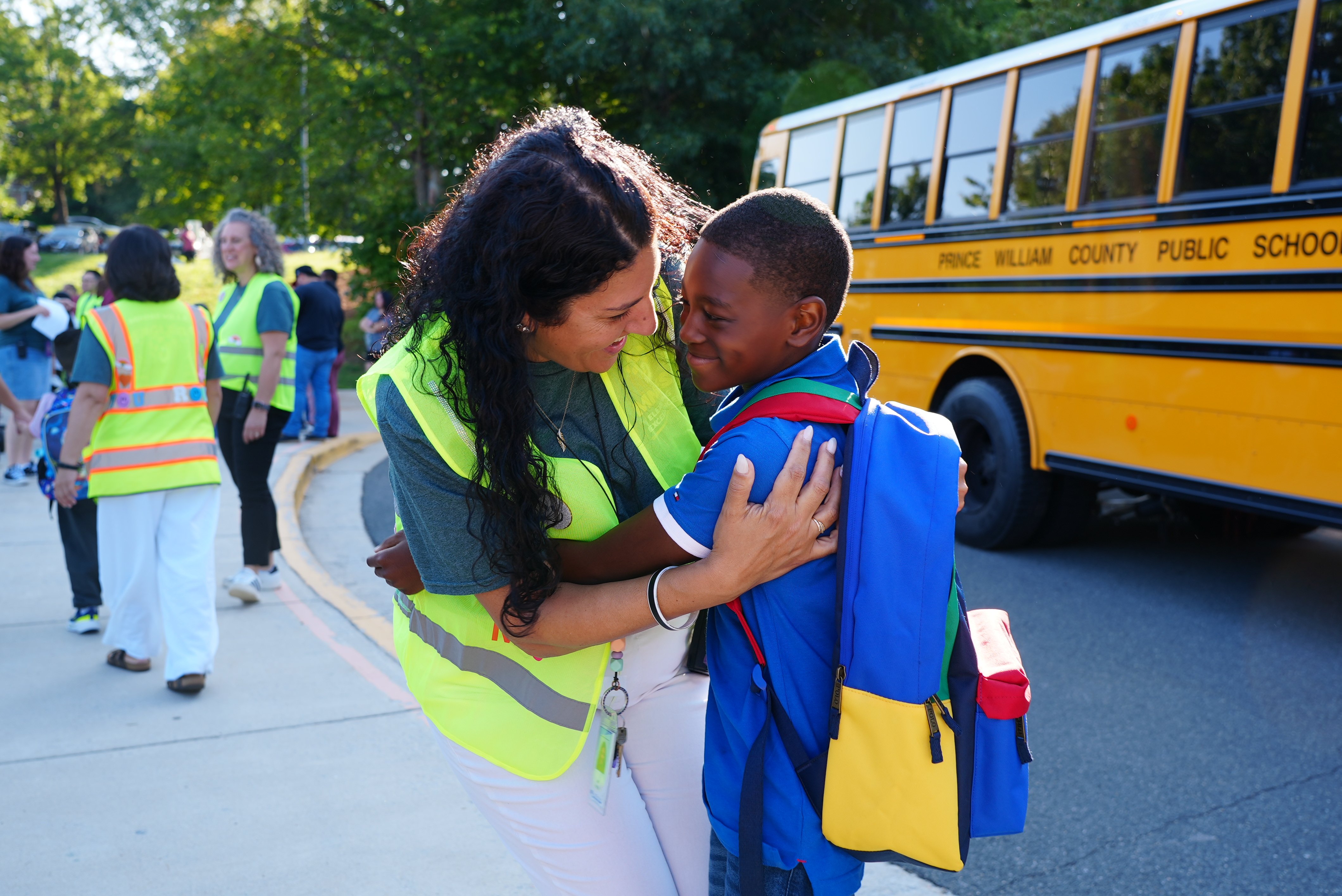 A teacher and student greet each other on the first day