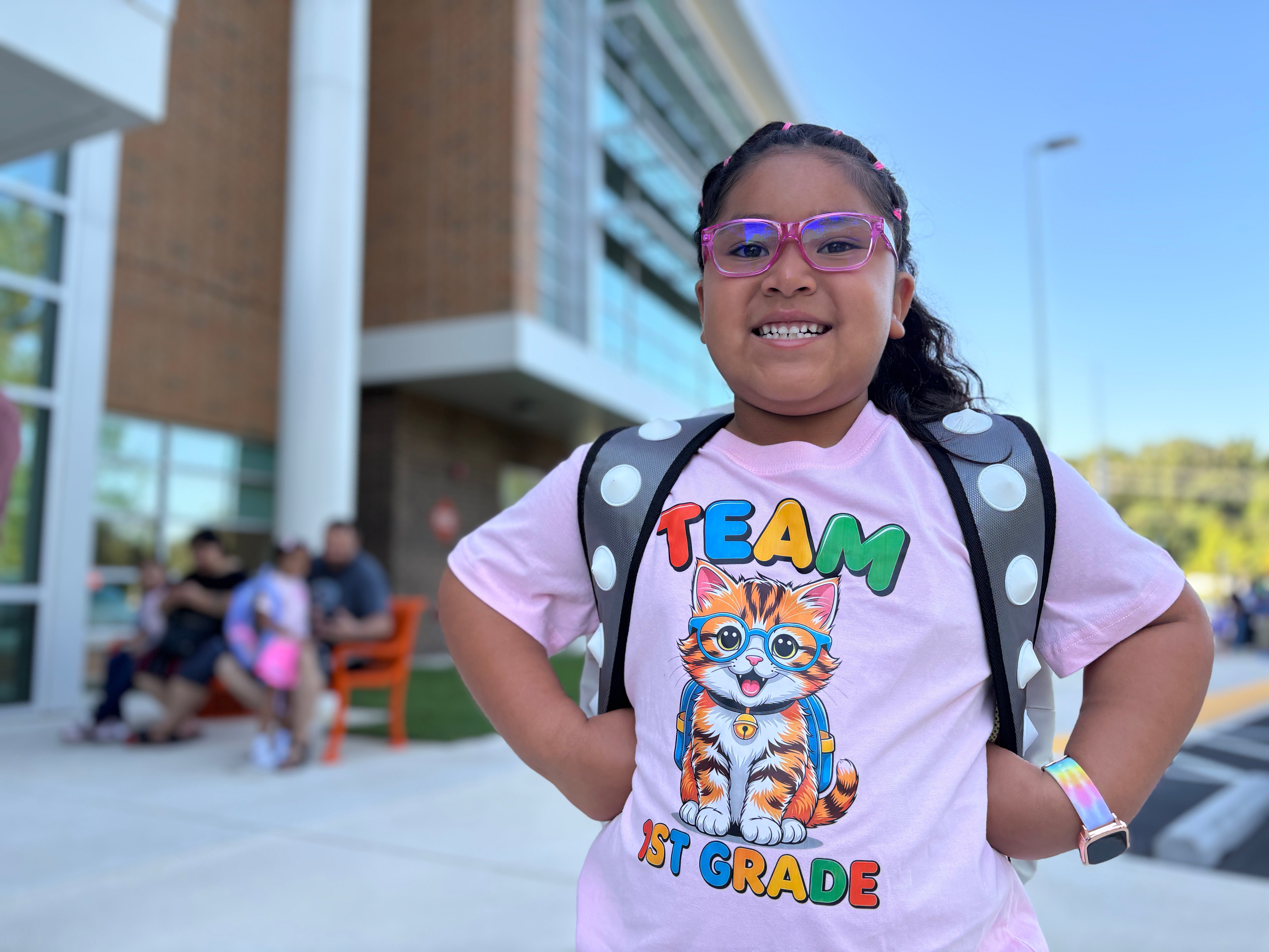 A student proudly wears a "team first grade" tshirt