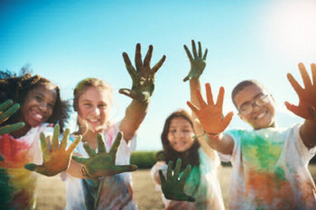 Children with paint on their held out hands