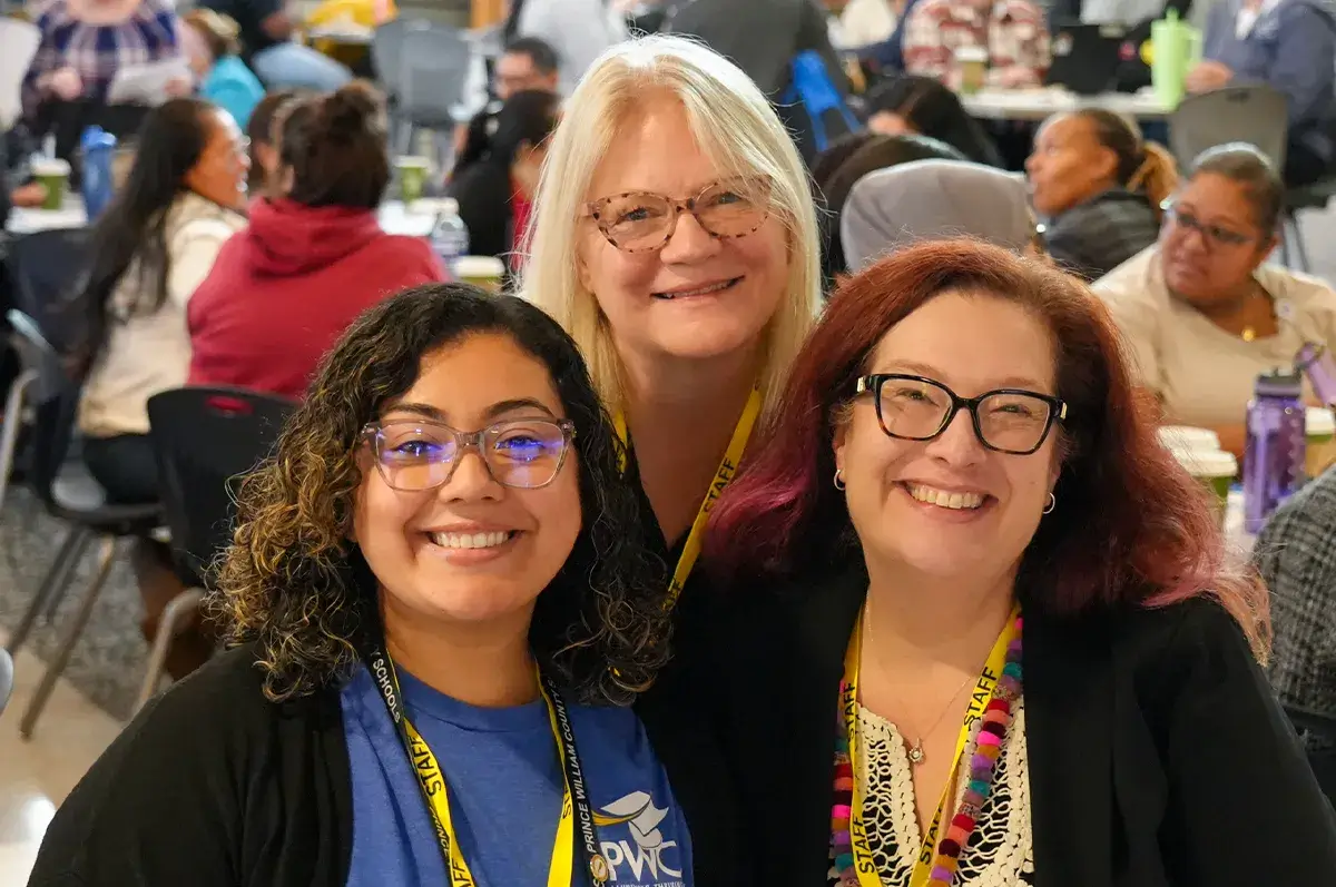 Three smiling PWCS staff members at the 2025 Classified Professional Development Conference
