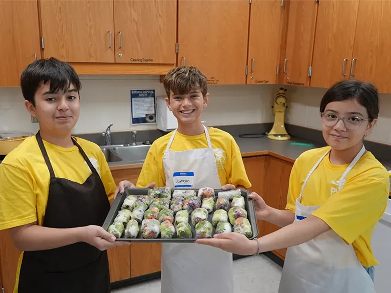 Students participating in a cooking summer enrichment program