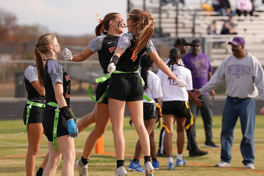 Brentsville District High School students chest bumping at the first-ever girl's flag football championship