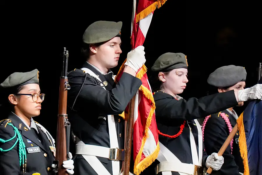 JROTC cadets holding flags on stage at cpdc 2025