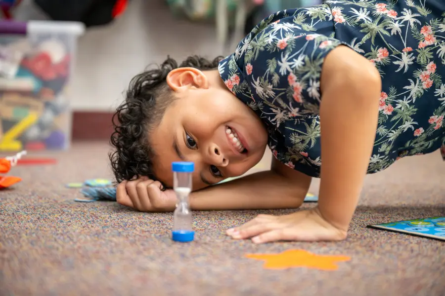 Elementary student looking at a sand timer