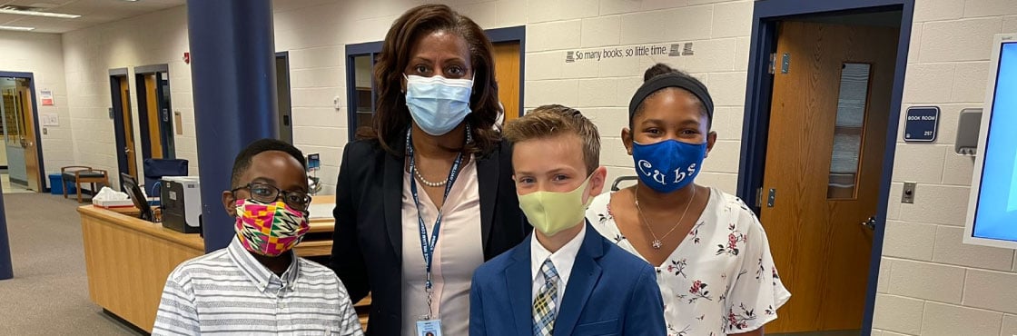 Dr. McDade with three elementary school students.