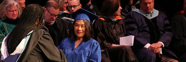 female adult graduate at graduation