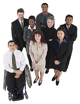 Diverse group of workers with seven standing and one seated in a wheelchair Diverse group of workers with seven standing and one seated in a wheelchair