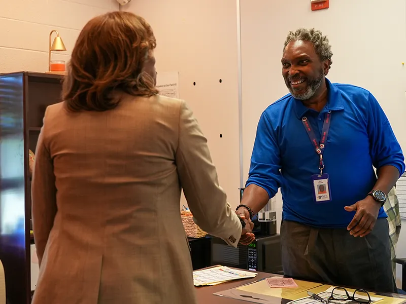 Dr. McDade shaking the hand of a counselor