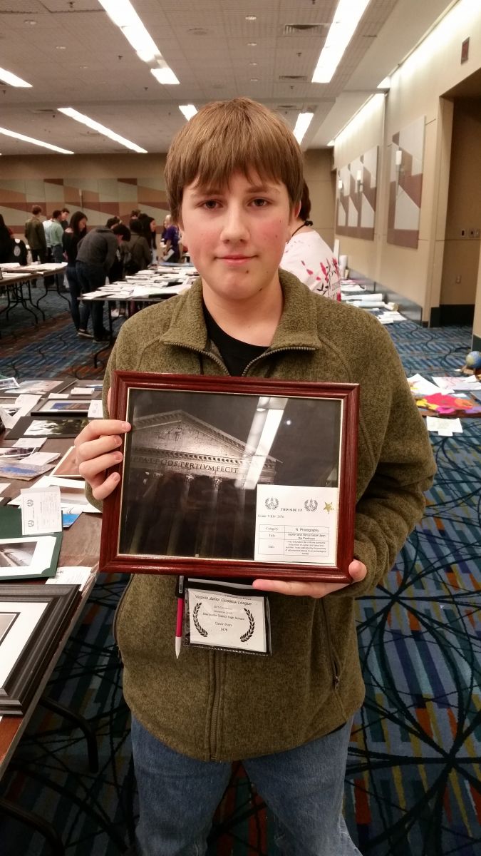Brentsville student holding an award
