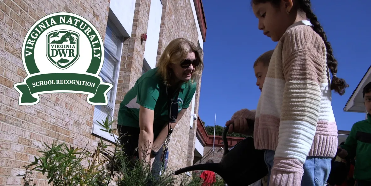 Children watering plants outside their school with the Virginia Naturally logo on the photo