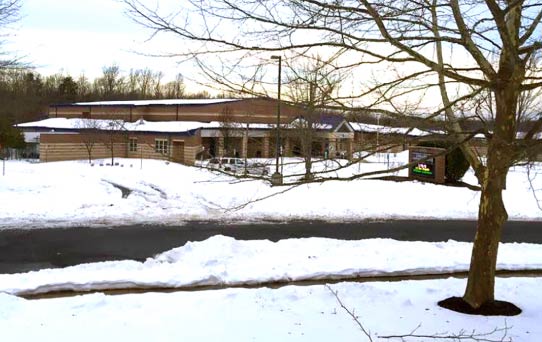 School building and parking lot with snow
