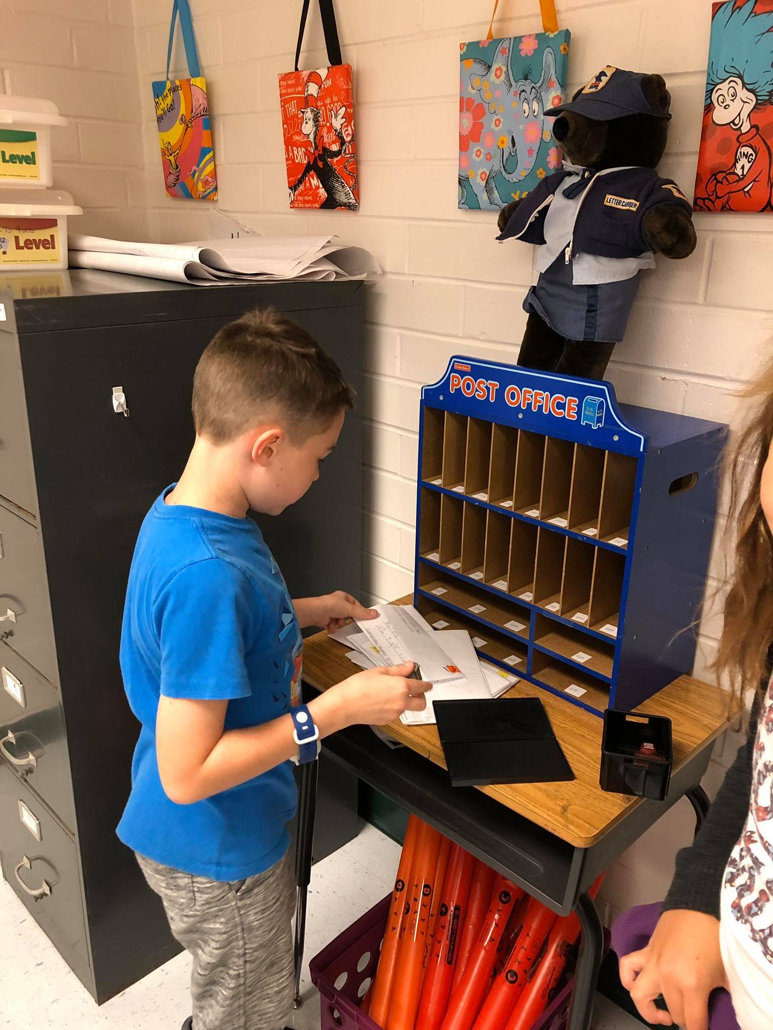 Student sorts mail at Wee Deliver Post Office
