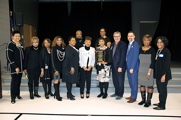 Coalition members and PWCS representatives hold plaque awarded to Jenkins Elementary