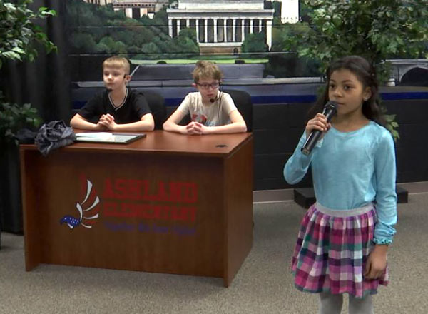 Three students announcing the Ashland Morning News