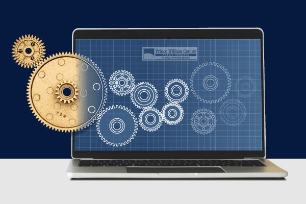 An open laptop with images of gears on the screen