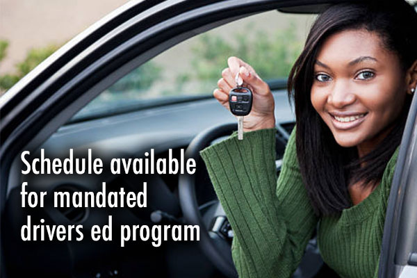 teen girl smiling while holding car keys leaning out window of car