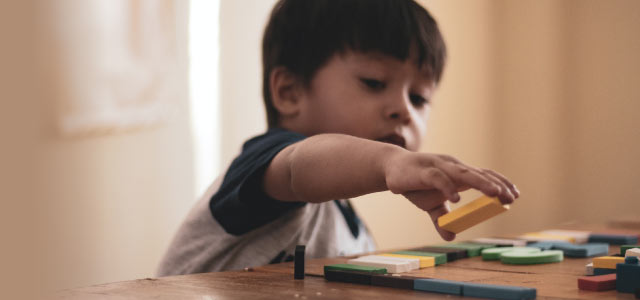 Young child playing with blocks.