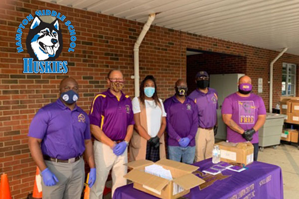 Omega Psi Phi members stand ready to help with masks on