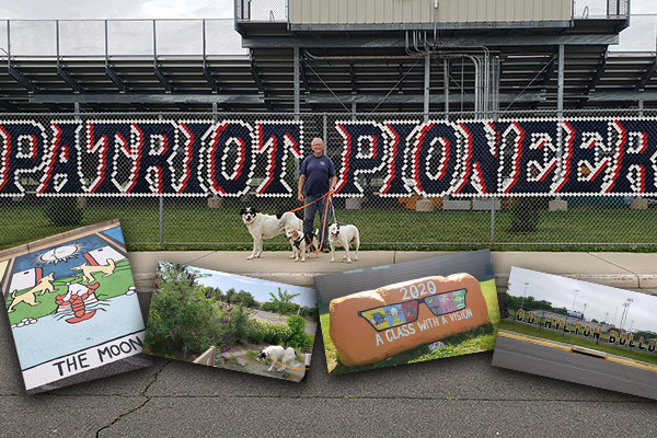 Harold James standing in front of fence at Patriot High School with his three dogs.