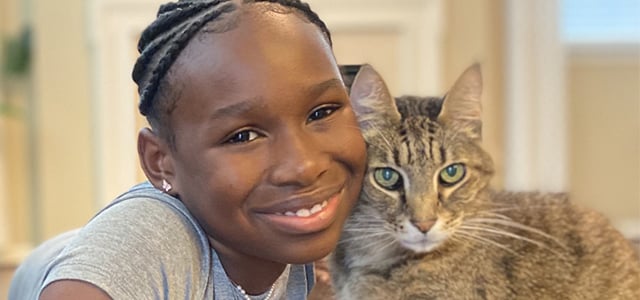 Head shot of Tiana Price and her grey cat