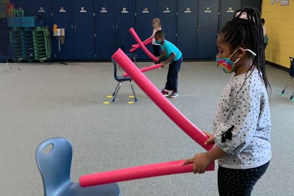 Covington-Harper ES students using pool noodles during a music lesson