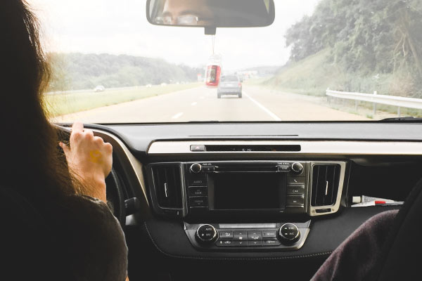 back seat view photo of a person's head in the driver's seat