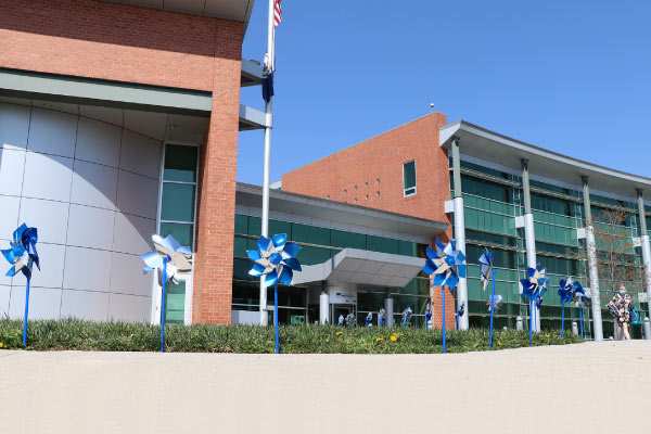 Kelly Leadership Center with blue pinwheels outside