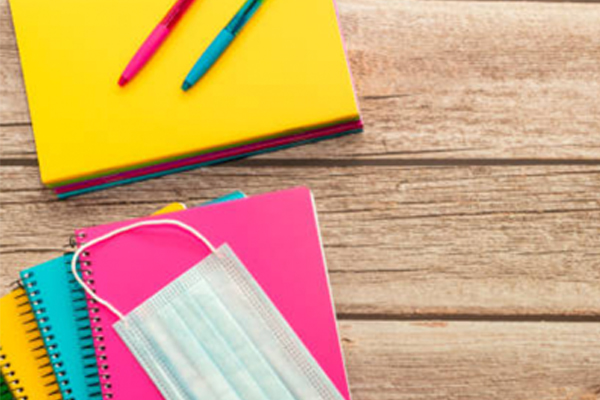 colorful summer image of school books and a face covering mask