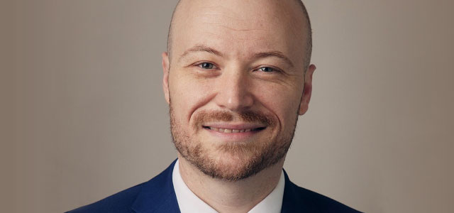 Head shot of Adam Russo