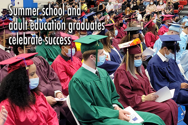 2021 adult and summer school 2021 graduates sitting in cap and gown at ceremony