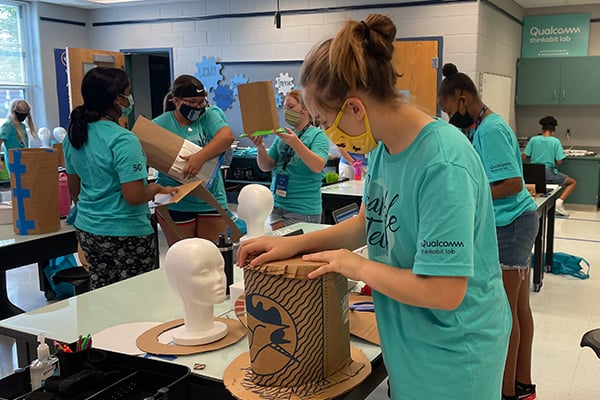 Students designing and constructing automated hats 