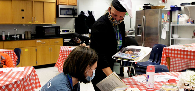 Forest Park individual with books on serving tray