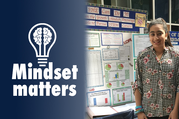 Rania Lateef standing next to standing growth mindset project poster board.