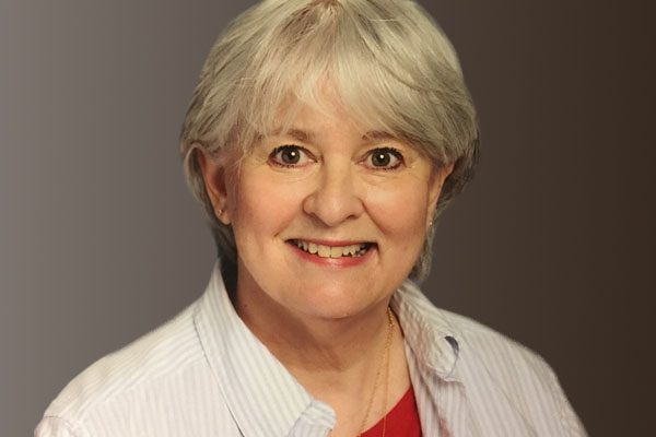 smiling close up headshot photo of PWCS teacher Debra Peterman in collared shirt