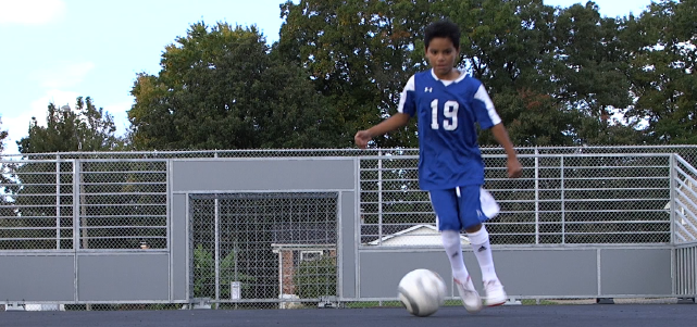 Student playing futsal on mini-pitch at Hampton Middle School