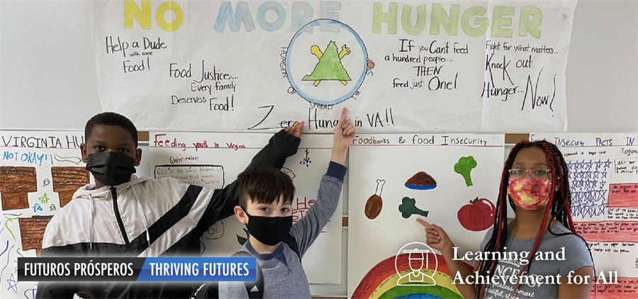 Three King Elementary School students standing in front of a hunger awareness poster