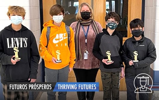 Four students holding trophies with teacher. Futuros Prosperos. Thriving Futures.