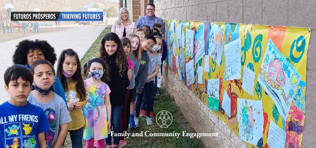 Buckland Mills Elementary School standing next to the banner that they created