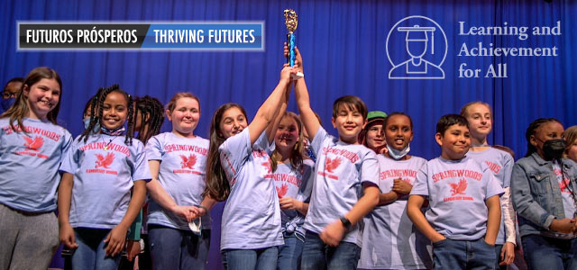 Springwoods Elementary School students holding up a trophy at the Battle of the Books