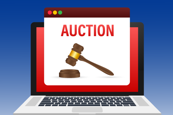 Gavel ready to bang down on a surface with the words "AUCTION" in red font on a white background.