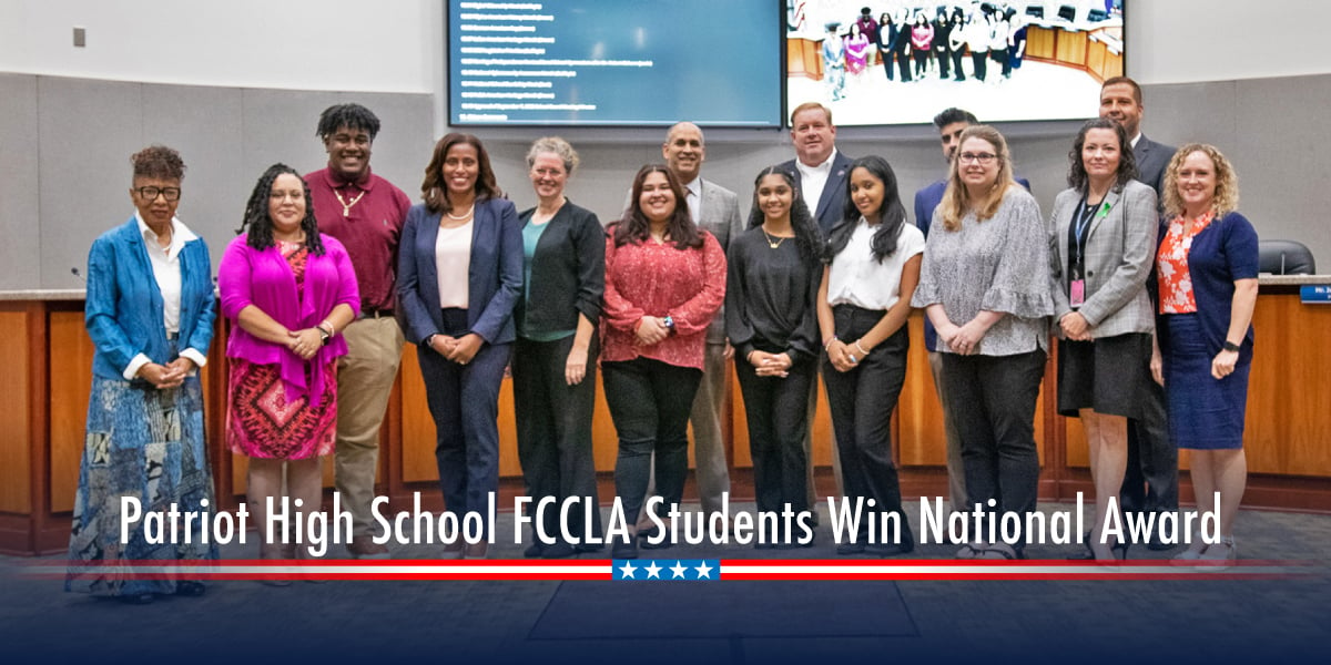 Patriot students pictured with the School Board. Patriotic ribbon on bottom.